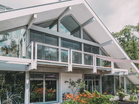 Modern timber frame villa with glass facade and garden