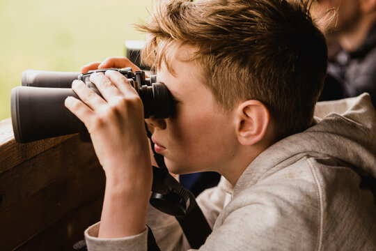 Boy birdwatching with binoculars
