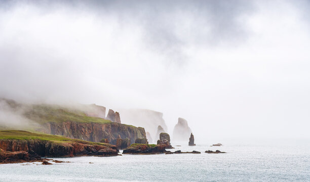 UK, Scotland, View of Drongs sea stacks during foggy weather