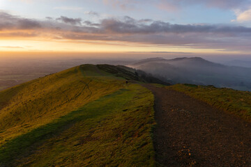 Fototapeta premium Misty, early morning sunrise over the Malvern Hills in December, Worcestershire, England