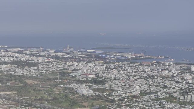 Scenic coastal view of Vung Tau, Ho Chi Minh City, Vietnam, filmed from the sea toward Go Gang Island, revealing the city skyline, coastline and distant harbor facilities.