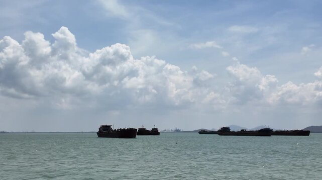 view of sea ferry cruising across Ganh Rai Bay from Can Gio, Ho Chi Minh City to Vung Tau City, Ba Ria - Vung Tau Province, Vietnam, surrounded by busy marine traffic and cargo ships.