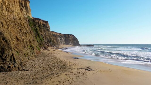 Half Moon Bay aerial low glide beach to cliffs