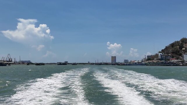 view of sea ferry cruising across Ganh Rai Bay from Can Gio, Ho Chi Minh City to Vung Tau City, Ba Ria - Vung Tau Province, Vietnam, surrounded by busy marine traffic and cargo ships.