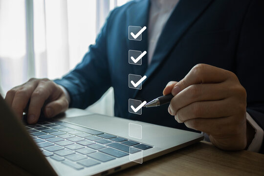 Businessman writing correct mark to approve document icon.quality management with quality assurance or QA and quality control or QC and improvement, Standardization and certification concept.