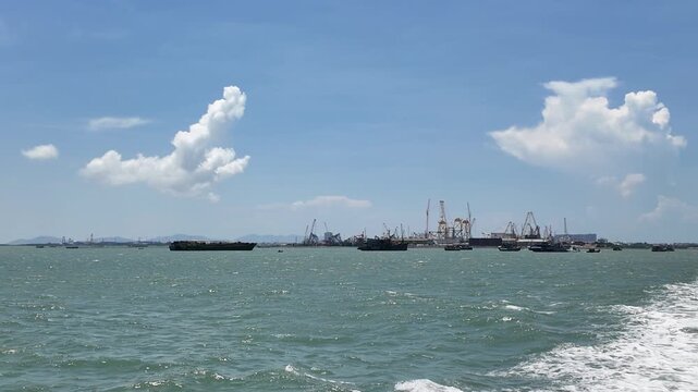 view of sea ferry cruising across Ganh Rai Bay from Can Gio, Ho Chi Minh City to Vung Tau City, Ba Ria - Vung Tau Province, Vietnam, surrounded by busy marine traffic and cargo ships.