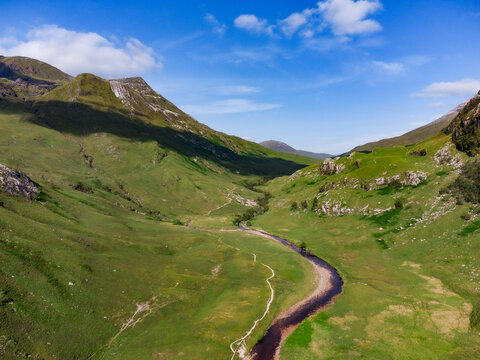 Aerial drone view above a green Ben Nevis River Valley natural environment landscape in Scotland Highlands 