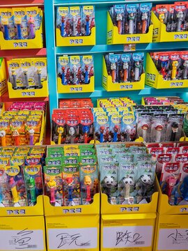 SHANGHAI, CHINA - Large store display filled with colorful PEZ candy dispensers featuring famous movie and cartoon characters on shelves. Editorial use only