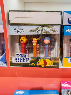 Official PEZ candy dispenser set featuring Disney Winnie the Pooh, Tigger, and Eeyore in original packaging box on store shelf. Editorial use only