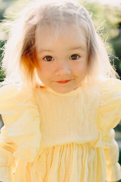 Close up portrait of beautiful child girl in yellow
