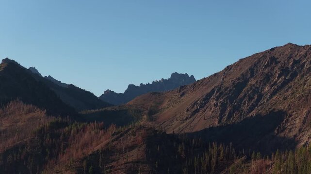Aerial of Wenatchee National Forest at sunset with jagged mountain ridge and deep valleys in Cle Elum Washington