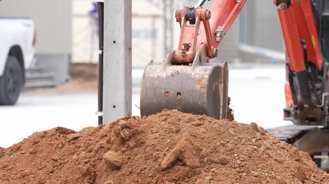 Excavator bucket soil digging construction machinery earthwork trench hydraulic excavation, heavy equipment lifting dirt, loading clay, roadside utility line, industrial roadwork site scoop