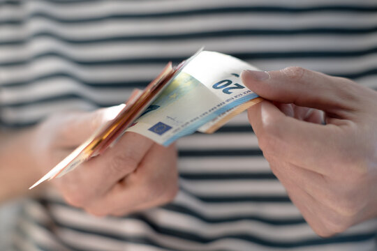 A euro banknote in a man's hand.

