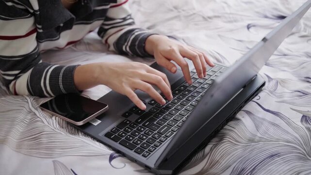 Woman typing on a laptop keyboard key, conveying typing, digital communication and focused office work.
