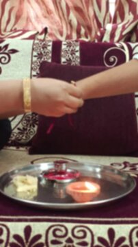Traditional Raksha Bandhan Pooja Thali with Rakhi, Diya, Sweets, and Kumkum for Indian Festival Celebration
