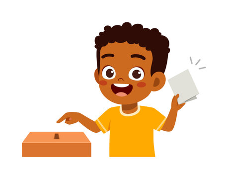 Happy Black boy smiling holding a ballot and pointing at the voting box for election