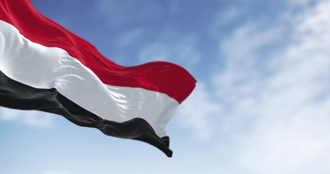 Yemen national flags waving on a clear day