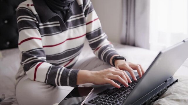 Woman typing on a laptop keyboard key, conveying typing, digital communication and focused office work.