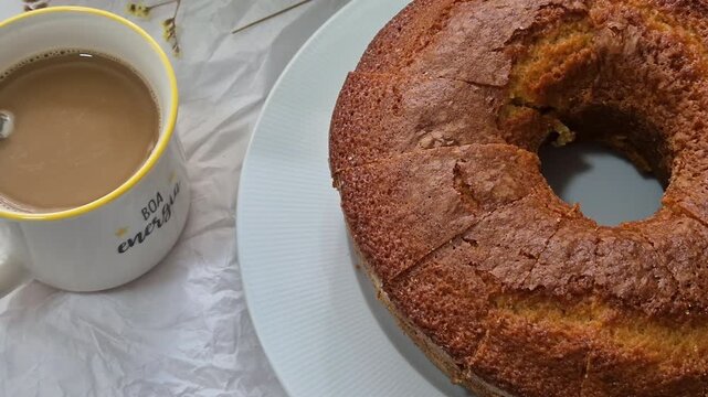 Fresh homemade cake served with a cup of coffee, perfect for breakfast or an afternoon snack. Warm, comforting and inviting homemade food concept.