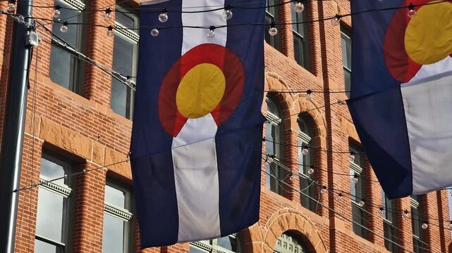 Colorado State Flags Hanging on Larimer Square in Downtown Denver USA in Front of Historic Buildings