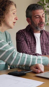 Mature couple managing home finances together