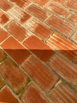 Close-Up of Terracotta Brick Paving with Diagonal Shadow