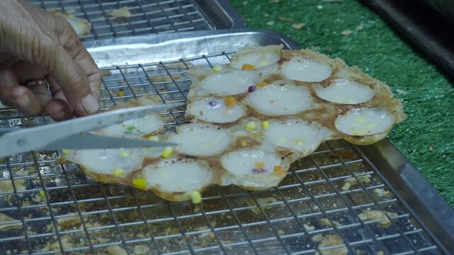 Khanom krok chao wang is a traditional thai dessert made from coconut milk and rice flour, cooked in an iron pan. Common toppings include thinly sliced ​​scallions, taro, corn, or pumpkin.
