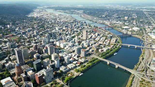 Aerial drone footage captures a beautiful scenic overview of Portland cityscape in motion during daytime.