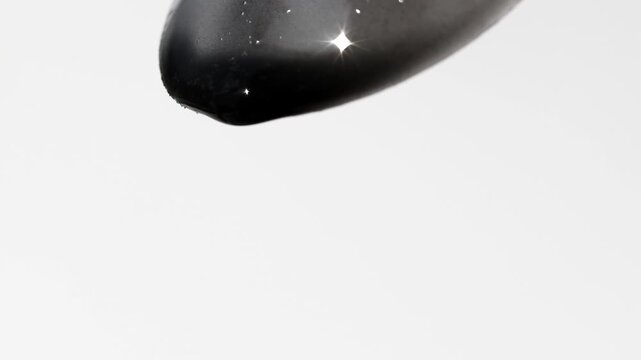 Black cosmetic liquid for cleansing and skin care, beauty texture.