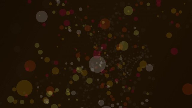 Abstract background featuring floating circular light particles in warm golden and dark maroon color tones