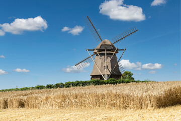 A partially harvested grain field with an old grain mill in the background – 9380 © Wolfgang Jargstorff