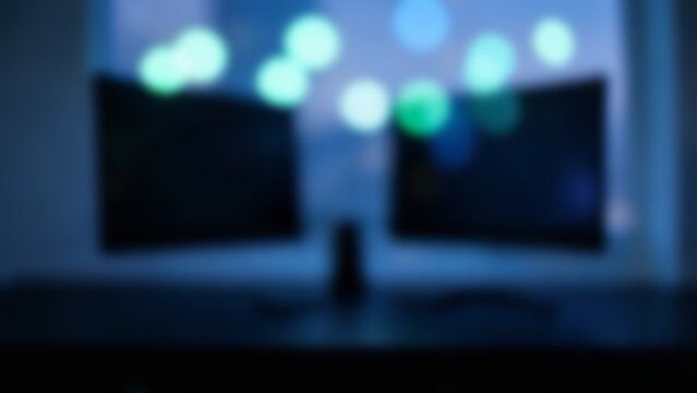 Abstract blurred dual monitor tech workspace background for