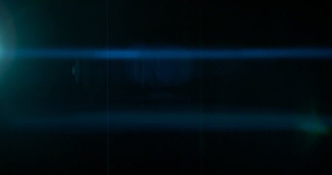 Abstract cinematic anamorphic lens flare overlay with blue horizontal light streaks and warm orange glow on a black background. Ideal VFX element for compositing, titles and film editing.