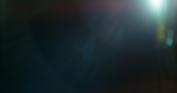 Abstract cinematic lens flare overlay with soft blue light rays, subtle optical glow and dark background. Premium VFX element for compositing, film editing, titles and motion graphics.