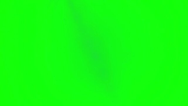 Confetti and red envelopes fall downward against a vibrant green screen background for celebratory video editing projects.