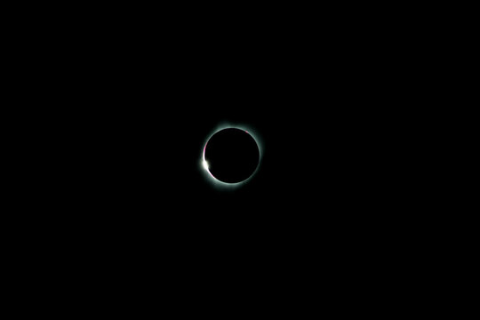 total solar eclipse with diamond ring and corona