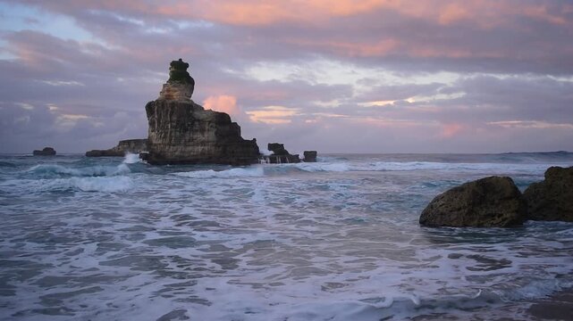 Majestic offshore rock formations rise from the sea of Buyutan Beach in Pacitan during twilight