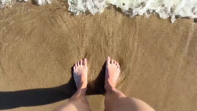 The ocean, river waves wash womans feet footage