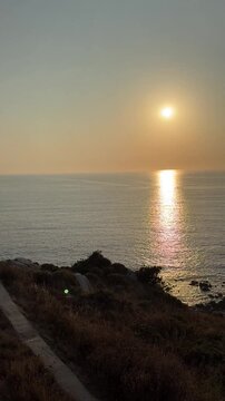 Golden Sunset Reflecting Over Atlantic Ocean and Rocky Coast in Baiona, Galicia, Spain
