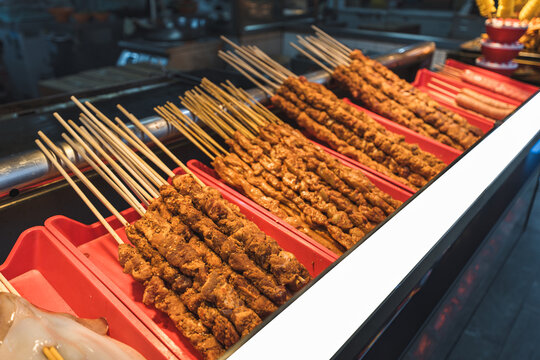Traditional Grilled Sichuan Pepper Meat Skewers on Display at Asian Street Food Market Stall Night