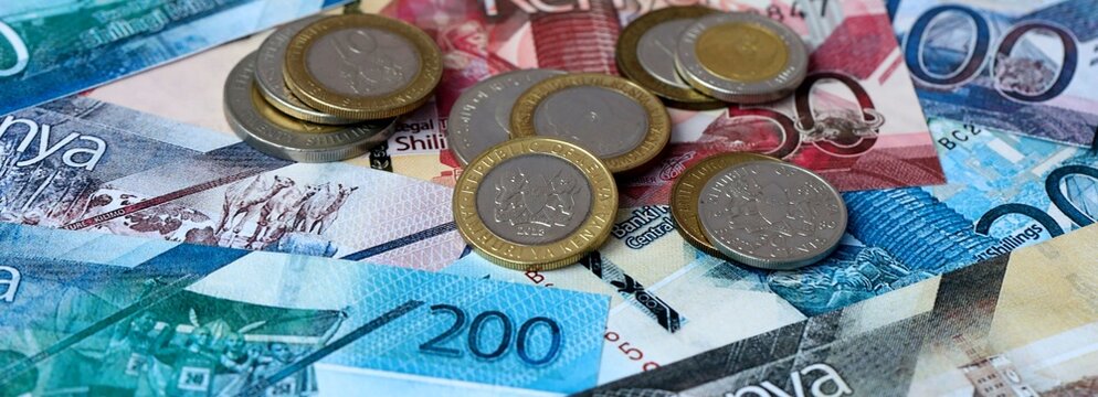 Kenyan shilling money banknotes and coins on table. Kenya cash bills of KES currency