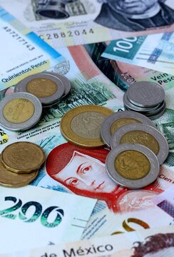 Mexican peso money banknotes and coins on table. Mexico cash bills of MXN currency