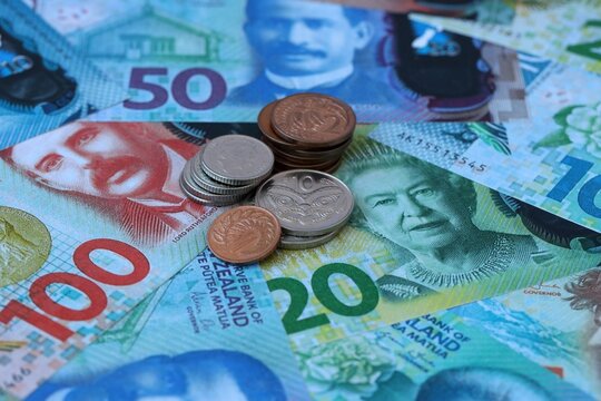 New Zealand dollar money banknotes and coins on table. New Zealand cash bills of NZD currency