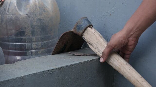 Hand Returning Hoe To Storage Close Up