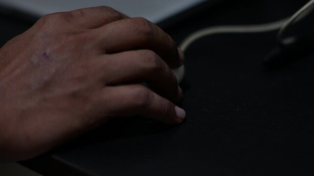 Close Up of Hand Using Computer Mouse on Desk