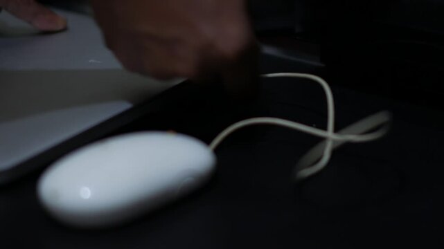 Close Up of Hand Plugging USB Mouse Cable into Laptop
