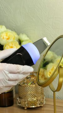 Ultrasonic skin scrubber is displayed against an elegant spa background, professional facial equipment, skincare technology, cosmetic presentation.