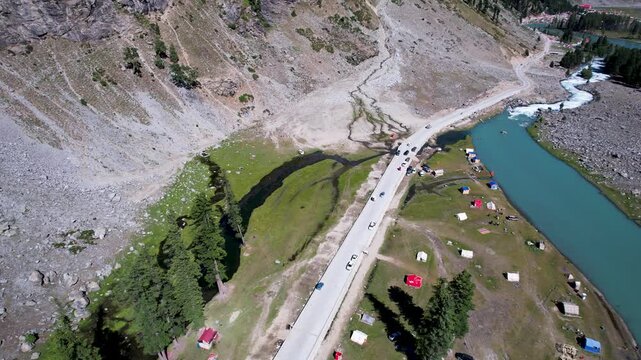 Campsites line the roadside beside Mahodand Lake in Ushu Valley, Khyber Pakhtunkhwa, Pakistan