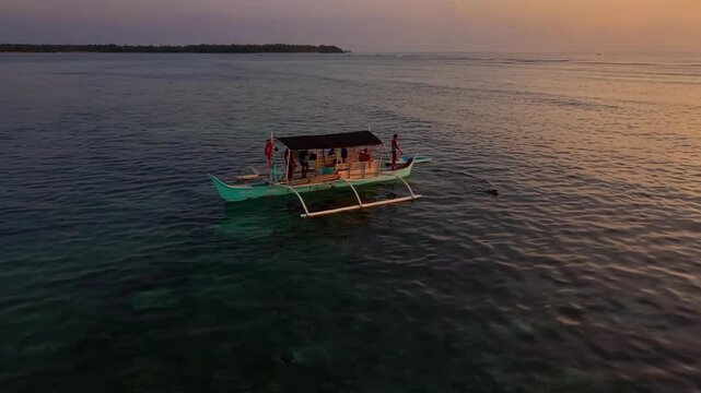 Drone aerial view of private surf boat at sunrise in Siargao, Philippines