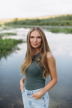 Young woman enjoying nature standing by river